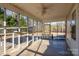 Bright screened porch with ceiling fan at 41943 Gurley Rd, New London, NC 28127