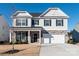 Two-story house with gray siding, stone accents, and a white garage door at 4479 Dover Ct, Denver, NC 28037