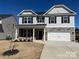 Two-story house with gray siding, stone accents, and a two-car garage at 4479 Dover Ct, Denver, NC 28037