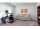 Bright home office featuring a desk, sofa, and built-in bookcase at 4479 Dover Ct, Denver, NC 28037