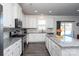 Modern kitchen with white cabinets and granite countertops at 4479 Dover Ct, Denver, NC 28037