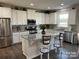 Spacious kitchen featuring white cabinets, granite countertops, and an island at 4479 Dover Ct, Denver, NC 28037