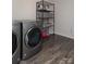 Convenient laundry room with washer, dryer, and storage shelves at 4479 Dover Ct, Denver, NC 28037