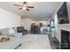 Open concept living room with fireplace and view into kitchen and dining area at 4479 Dover Ct, Denver, NC 28037