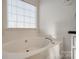 Relaxing bathroom with large garden tub and window at 4649 Maple Crest Pl, Harrisburg, NC 28075