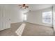 Bright bedroom featuring carpet flooring and large window at 4649 Maple Crest Pl, Harrisburg, NC 28075