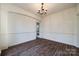 Bright dining room with chandelier and wood-look floors at 4649 Maple Crest Pl, Harrisburg, NC 28075