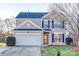 Two-story house with taupe vinyl siding, white garage door, and landscaping at 4649 Maple Crest Pl, Harrisburg, NC 28075