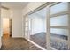 Hallway with sliding glass doors and wood-look floors at 4649 Maple Crest Pl, Harrisburg, NC 28075