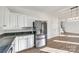 Modern kitchen featuring stainless steel appliances and white cabinetry at 4649 Maple Crest Pl, Harrisburg, NC 28075