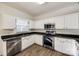 Kitchen with white cabinets, granite countertops, and stainless steel appliances at 4649 Maple Crest Pl, Harrisburg, NC 28075