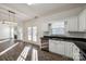 Bright kitchen with white cabinets, granite counters, and stainless steel appliances at 4649 Maple Crest Pl, Harrisburg, NC 28075