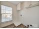 Laundry room with built-in cabinets and a window at 4649 Maple Crest Pl, Harrisburg, NC 28075