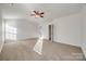 Spacious main bedroom with carpeted floors and ceiling fan at 4649 Maple Crest Pl, Harrisburg, NC 28075