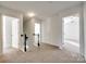 Upstairs hallway with neutral carpeting and access to bedrooms at 4649 Maple Crest Pl, Harrisburg, NC 28075