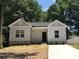 Newly constructed charming house with gray siding, a neatly landscaped yard and driveway at 5-1/2 B Seminole St, Gastonia, NC 28054