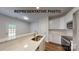 Modern kitchen with an island, stainless steel appliances, and white cabinets at 5-1/2 B Seminole St, Gastonia, NC 28054