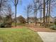 Private backyard with mature trees and large homes nearby at 5124 Craftsman Ridge Dr, Matthews, NC 28104