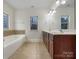 Bathroom with double vanity, tile flooring and a garden tub at 5124 Craftsman Ridge Dr, Matthews, NC 28104