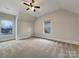 Bright bedroom with carpet flooring and two windows at 5124 Craftsman Ridge Dr, Matthews, NC 28104