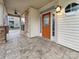 Front porch with stone accents and an orange front door at 5124 Craftsman Ridge Dr, Matthews, NC 28104