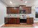 Kitchen with dark brown cabinets and stainless steel appliances at 5124 Craftsman Ridge Dr, Matthews, NC 28104