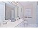 Clean bathroom boasts double sinks, a shower, and updated tile at 5921 Marshbank Ln, Charlotte, NC 28269