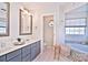 Bathroom with dual vanity, a large soaking tub, and separate shower at 5921 Marshbank Ln, Charlotte, NC 28269