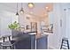 Island kitchen with dark-stained island, white cabinetry, and stainless steel appliances at 5921 Marshbank Ln, Charlotte, NC 28269