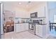 Bright kitchen with white cabinets, granite countertops and stainless steel appliances at 5921 Marshbank Ln, Charlotte, NC 28269