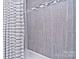 Shower stall with gray tile and a striped shower curtain at 5921 Marshbank Ln, Charlotte, NC 28269