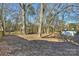 Large backyard with mature trees and storage shed at 6706 Queensberry Dr, Charlotte, NC 28226