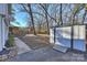 Backyard with shed, walkway, and mature trees at 6706 Queensberry Dr, Charlotte, NC 28226