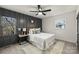 Cozy bedroom with dark gray accent wall, ceiling fan, and a queen bed at 6706 Queensberry Dr, Charlotte, NC 28226