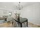 Spacious dining area features a black table, chandelier, and neutral decor at 6706 Queensberry Dr, Charlotte, NC 28226