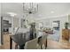 Modern dining room with kitchen view and chandelier at 6706 Queensberry Dr, Charlotte, NC 28226