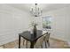 Elegant dining room with a black table, chandelier, and hardwood floors at 6706 Queensberry Dr, Charlotte, NC 28226