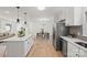 Renovated kitchen featuring white cabinets, quartz countertops, and stainless steel appliances at 6706 Queensberry Dr, Charlotte, NC 28226