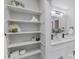 Bright bathroom with built-in shelving and updated finishes at 6762 Glenmoor Dr, Charlotte, NC 28214