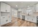 Modern kitchen with white cabinets, quartz countertops and stainless steel appliances at 6762 Glenmoor Dr, Charlotte, NC 28214