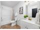 Clean bathroom with a white vanity, updated fixtures, and a bathtub at 7010 Sycamore Grove Ct, Charlotte, NC 28227