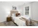 Spacious bedroom with a tufted headboard and neutral color scheme at 7010 Sycamore Grove Ct, Charlotte, NC 28227