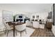 Bright dining area with a modern table and chairs, adjacent to living room at 7010 Sycamore Grove Ct, Charlotte, NC 28227