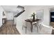 Dining area with wood table, beige chairs, and view into entryway at 7010 Sycamore Grove Ct, Charlotte, NC 28227