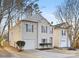 Two-story house with beige vinyl siding, white garage door, and landscaping at 7010 Sycamore Grove Ct, Charlotte, NC 28227