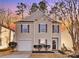 Charming two-story home features a cozy front porch, attached garage, and manicured landscaping at 7010 Sycamore Grove Ct, Charlotte, NC 28227