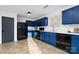 Modern kitchen with blue cabinets, white countertops, and black appliances at 7010 Sycamore Grove Ct, Charlotte, NC 28227