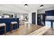 Modern kitchen with blue cabinets, breakfast bar, and black appliances at 7010 Sycamore Grove Ct, Charlotte, NC 28227