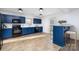 Modern kitchen with blue cabinets, stainless steel appliances, and an island at 7010 Sycamore Grove Ct, Charlotte, NC 28227