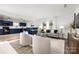 Modern kitchen with blue cabinets, black appliances, and a breakfast bar at 7010 Sycamore Grove Ct, Charlotte, NC 28227